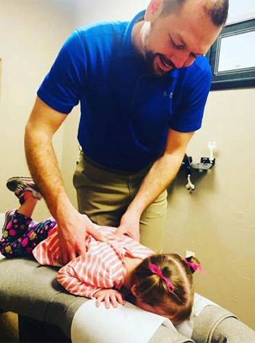 Chiropractor Edmond OK Devin Nightengale Adjusting Patient